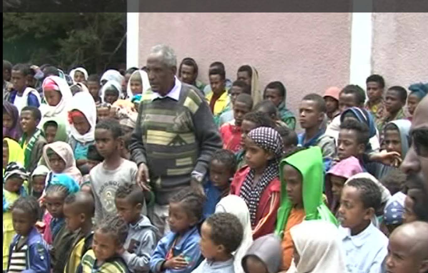 Ethiopian children in classroom, studying together, smiling, colorful school supplies, bright natural lighting, hopeful atmosphere, educational setting